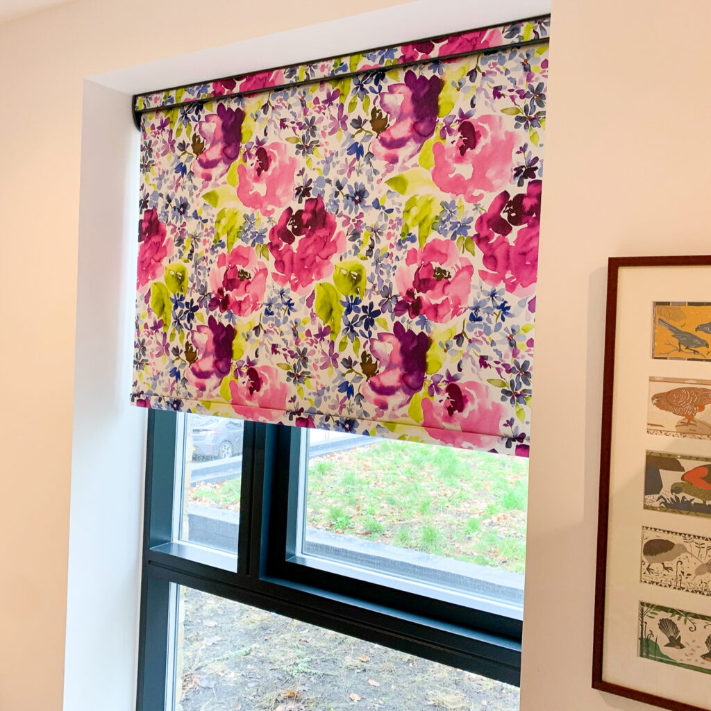 Bright floral roller blind in a bedroom window
