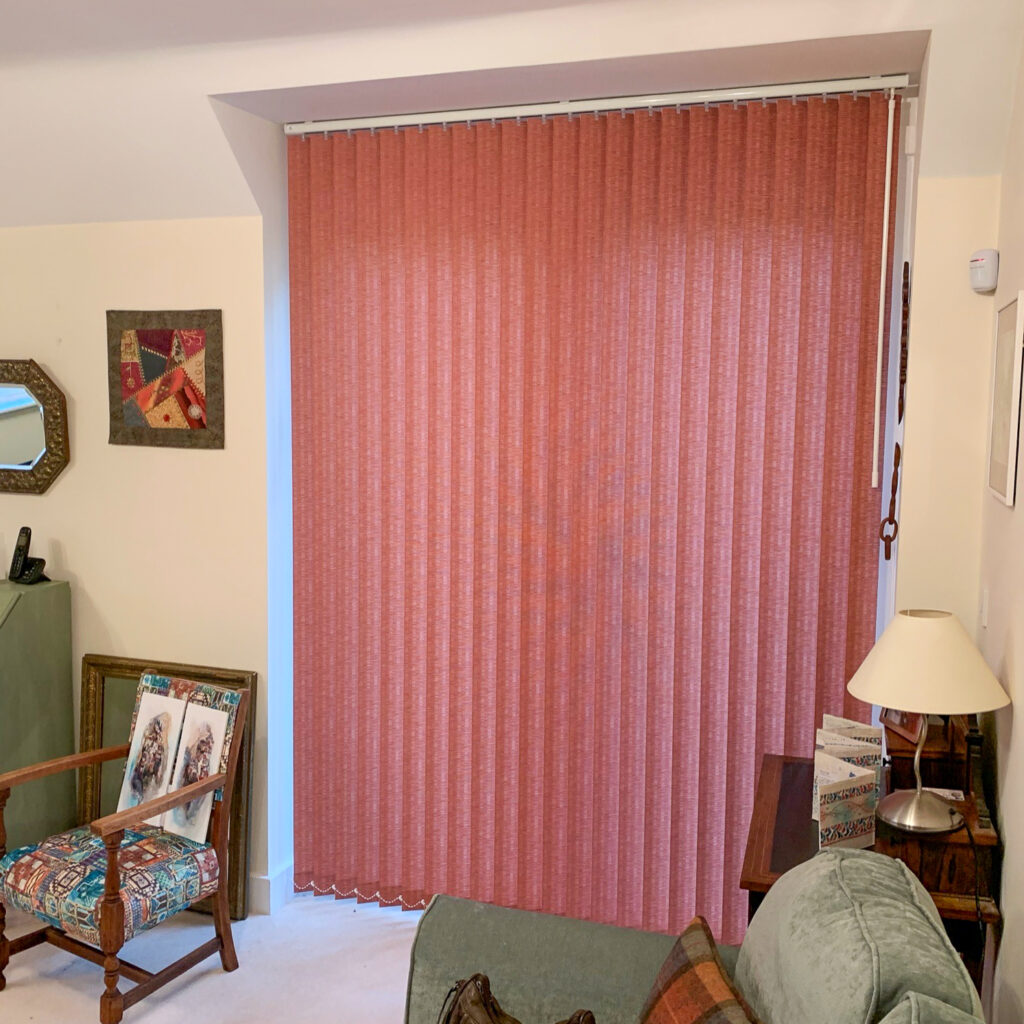 Red vertical blind in a living room window