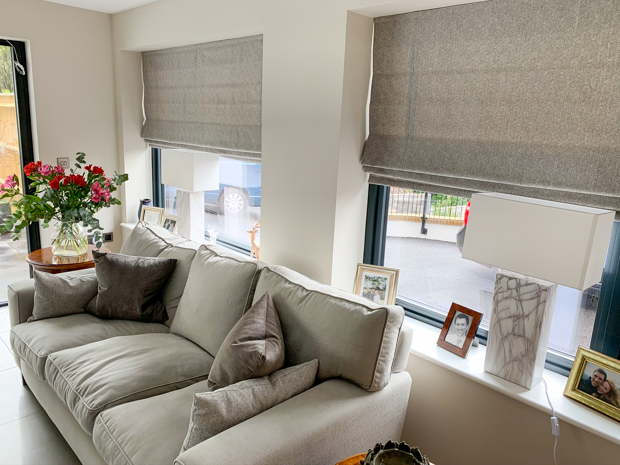 Grey Roman blinds in living room windows