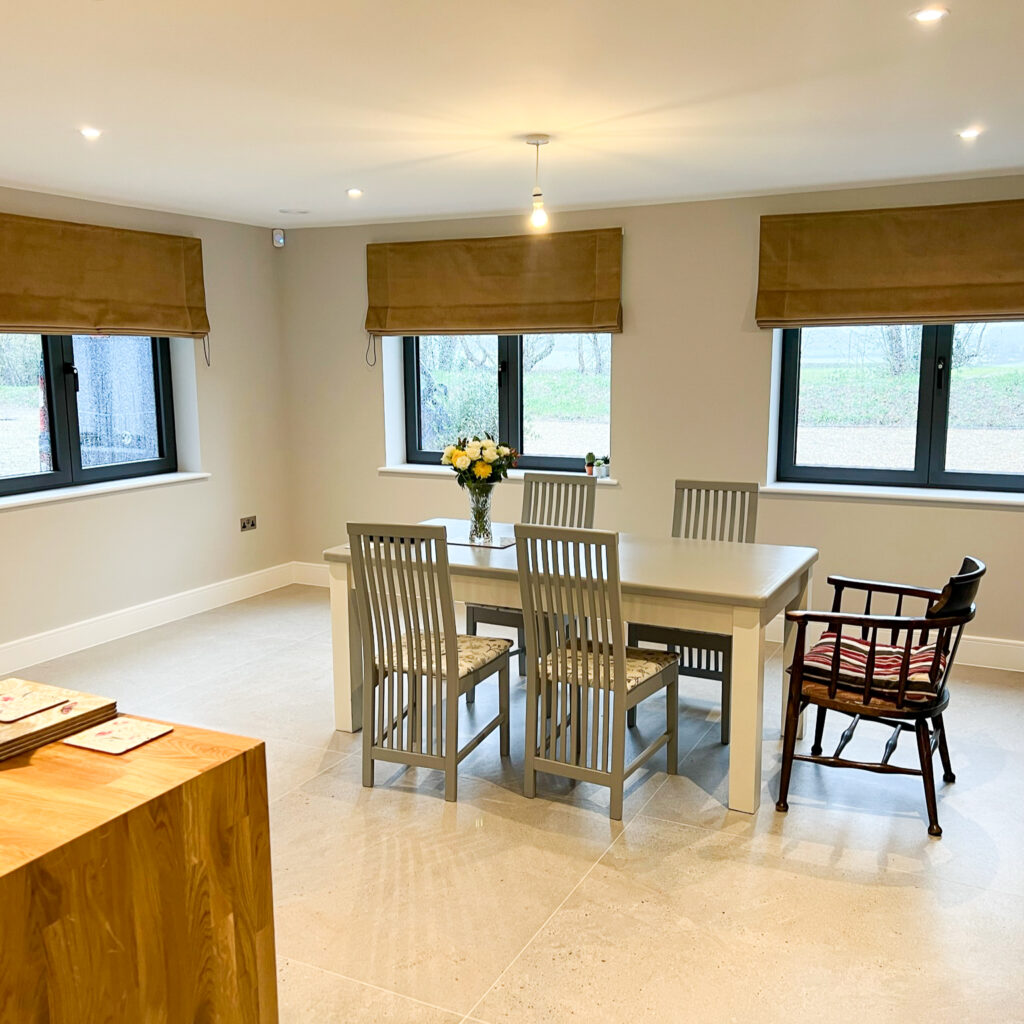 Yellow Roman blinds in a dining room