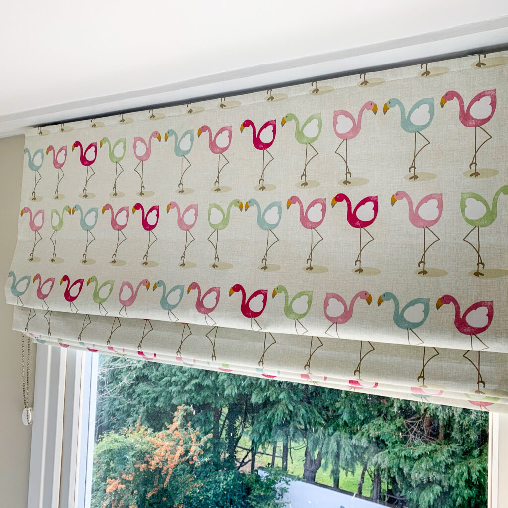Flamingo print blackout roman blind in bedroom window