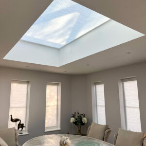 Cream Somfy electric roof lantern blind on a roof lantern window in a dining room